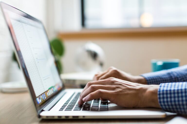 Employee using a laptop for AI-assisted work in the Philippines