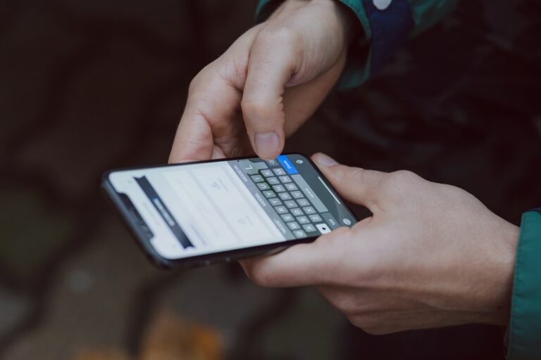 Person using smartphone for online scam complaint procedure in the Philippines